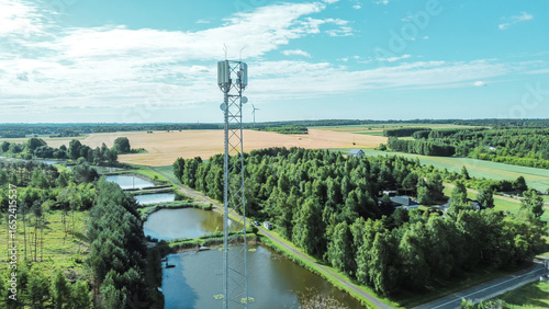 Fotografija Cell tower overlooking green countryside fields