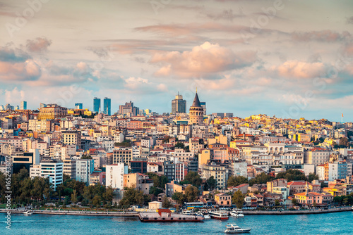 Beautiful view of Galata tower (Galata Kulesi) with Beyoglu district through Bosphorus Strait while viewed from Suleymaniye Mosque lookout at sunset time, Istanbul, Turkey