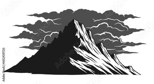 Mountain range shadowed by clouds contrasting dark jagged peaks