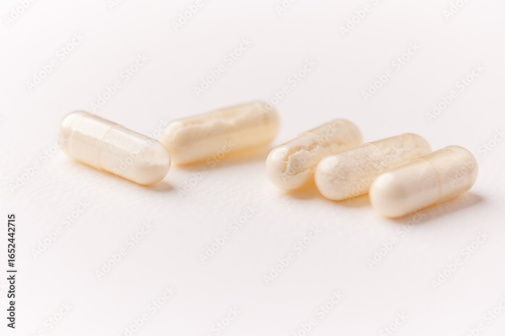 Coenzyme Q10 capsules. Antioxidants. Concept for a healthy dietary supplementation. Bright paper background. Soft focus. Close up. Copy space. Coenzyme Q10 capsules. Antioxidants. Concept for a healthy dietary supplementation. Bright paper background. Soft focus. Close up. Copy space.