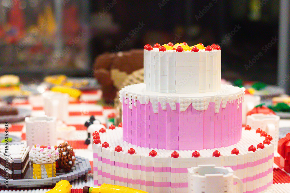 Naklejka premium Colorful lego cake with cherries and frosting