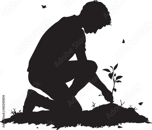 Tree Planting and Reforestation: A Silhouette of a Person Planting a Seedling in the Ground

