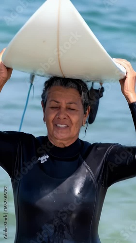 Senior woman with surfboard