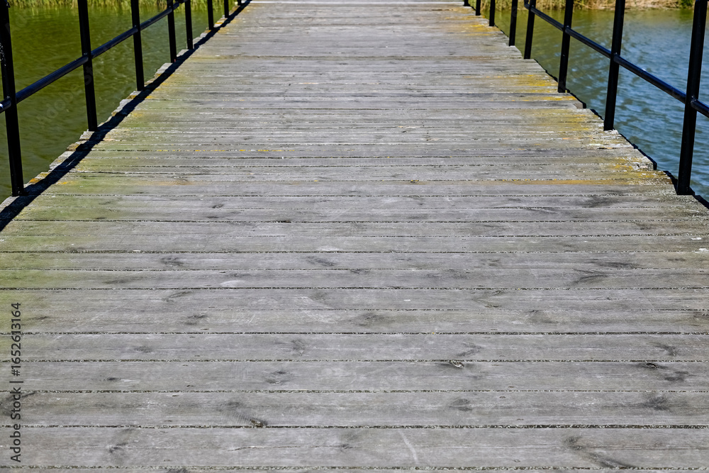 Obraz premium The flooring of the pier on Jamno Lake in the resort town of Mielno, Poland