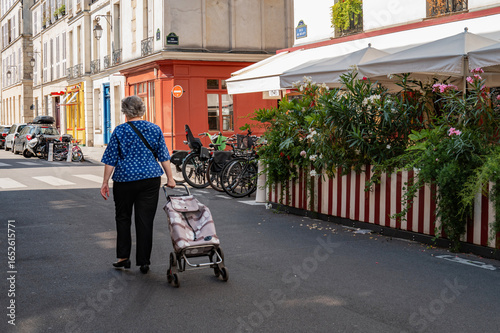 elderly woman walking in the street