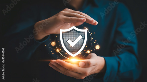 Person s hands protectively cradling a glowing digital shield with a checkmark symbolizing security and safety