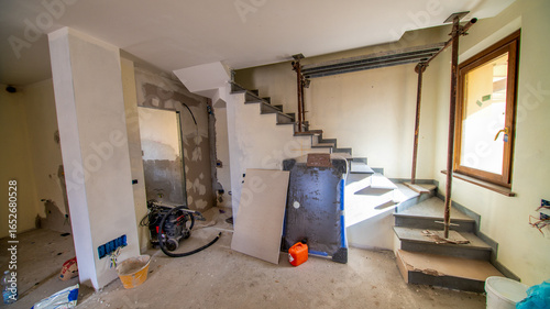 Construction Workers and Tools on Site for New House Renovation and Remodeling