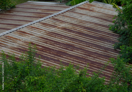 Surface of rusted zinc roof pattern, the old roof was rusted and color change to brown and yellow. it's effect from sun burn and life time used.
