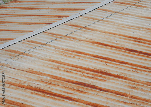 Surface of rusted zinc roof pattern, the old roof was rusted and color change to brown and yellow. it's effect from sun burn and life time used.