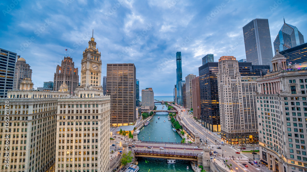 Fototapeta premium Chicago, IL - July 24, 2024: Aerial view of Riverfront and Skyscrapers at summer sunset