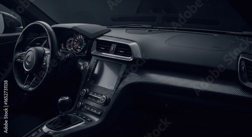 Dark, modern car interior.  Dashboard, steering wheel, and center console highlighted.  Sleek design