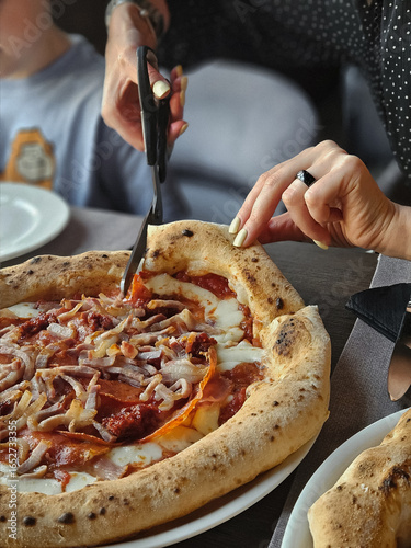 hand holding a pizza