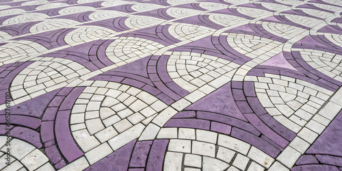 Purple and white decorative pavers forming elegant curved swirl patterns in alternating colors with intricate geometric mosaic design arrangement.