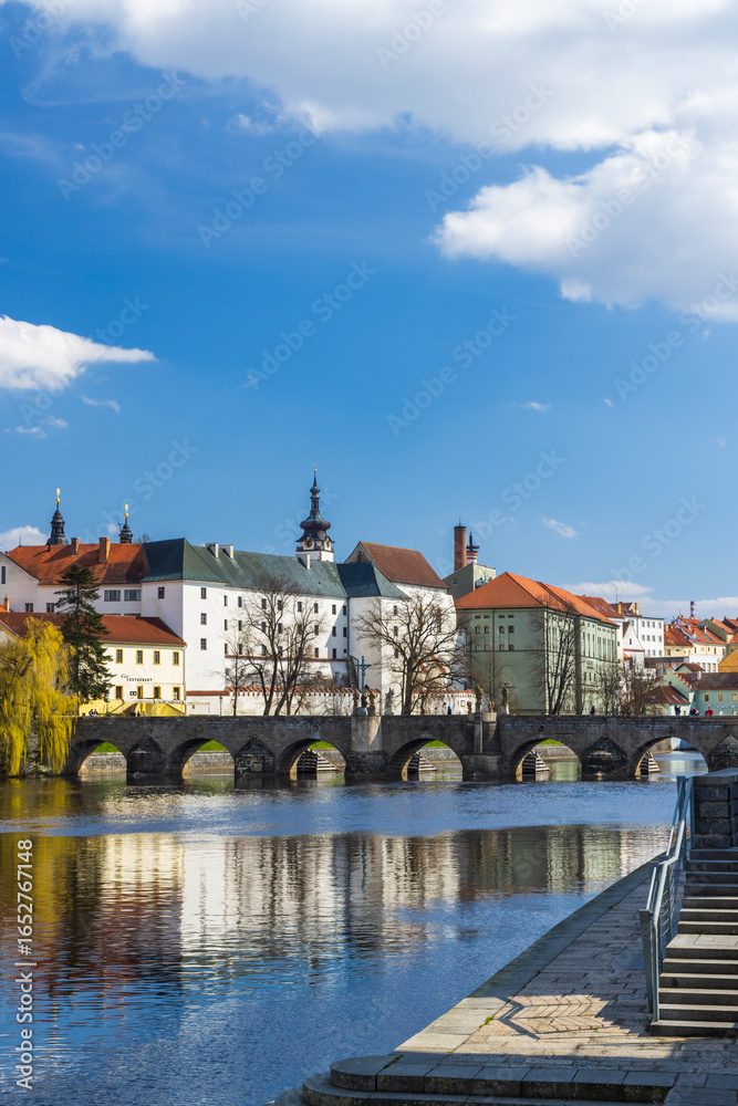 Fototapeta premium Stone Bridge reflecting on Otava River in Pisek, Czechia