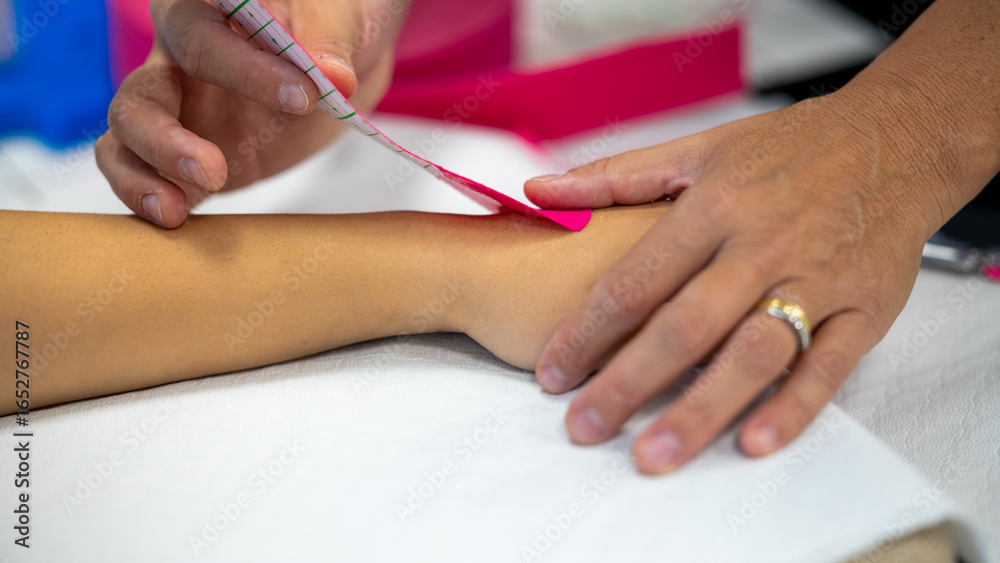 Wrapping elastic band around arm and wrist, physiotherapy Wrapping elastic band around arm and wrist, physiotherapy