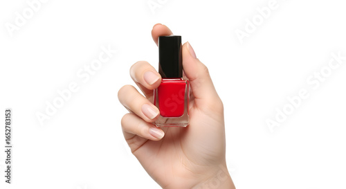 Hand Holding Red Nail Polish Bottle Demonstrating Manicure Application.