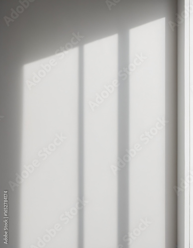 Minimal sunlight and window shadows on white wall
