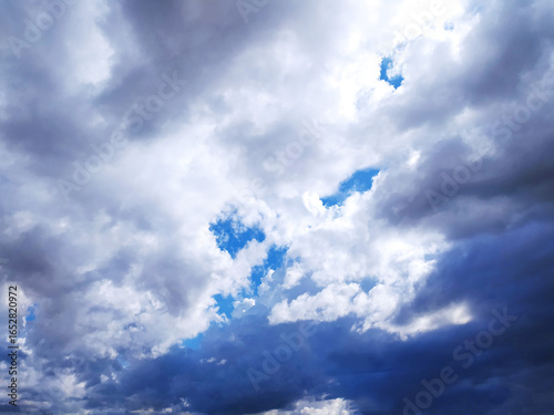 Fotografía Dramatic skyscape featuring dark storm clouds punctuated by patches of bright blue
