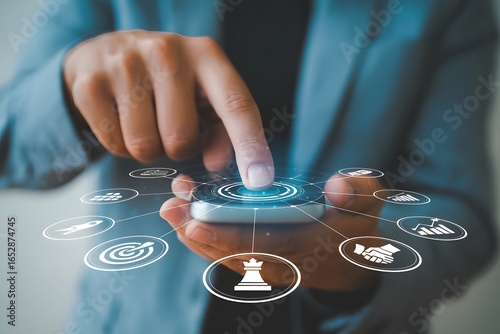 Businessman using a smartphone with business strategy icons representing digital transformation innovation and modern technology for business growth and success in the digital