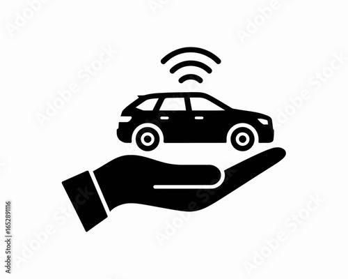 Silhouette of a car with wireless signal above it resting on an open hand isolated on white background