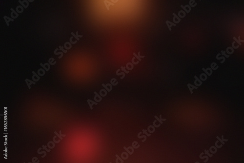 Blurred image of a person in red light with dark background