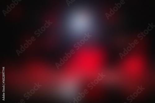 Mysterious figure in red and blue light amidst darkness