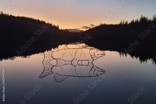 Sunrise over fish sculpture by Rob Mulholland