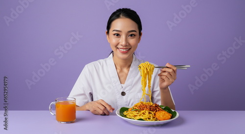 Smiling Asian Woman Enjoying Noodles with Orange Juice on Purple Background
