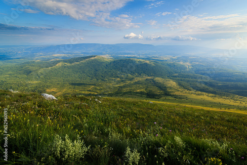 A picturesque view from the hiking path of Rtanj mountain in Eastern Serbia, showcasing its lush greenery and expansive landscapes.
