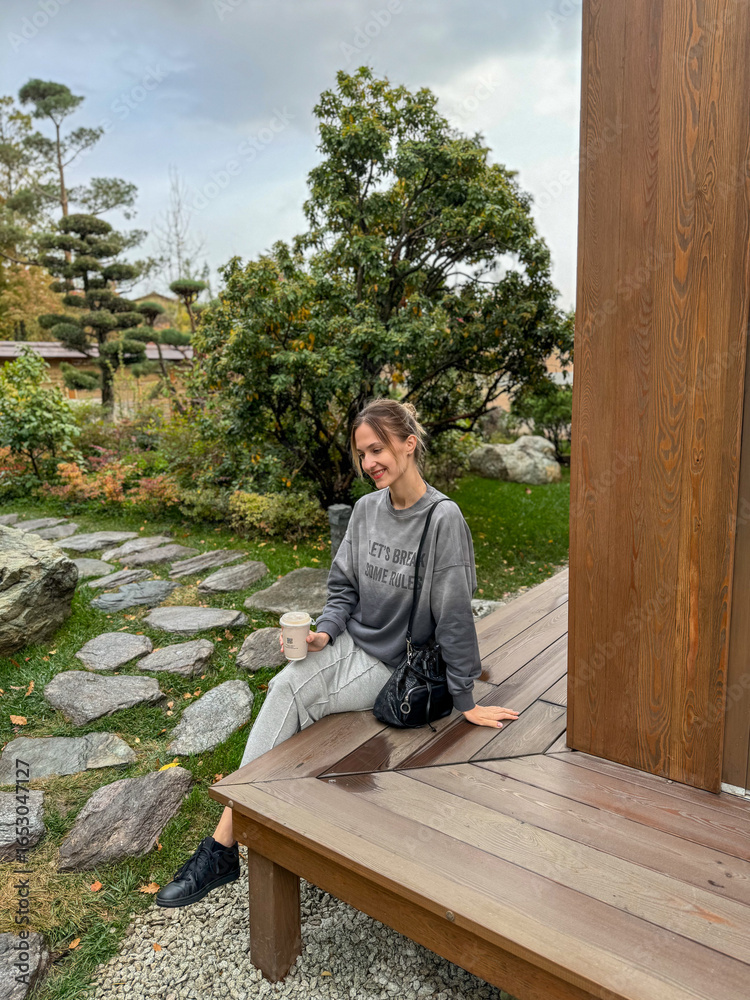 Fototapeta premium woman sitting on a bench