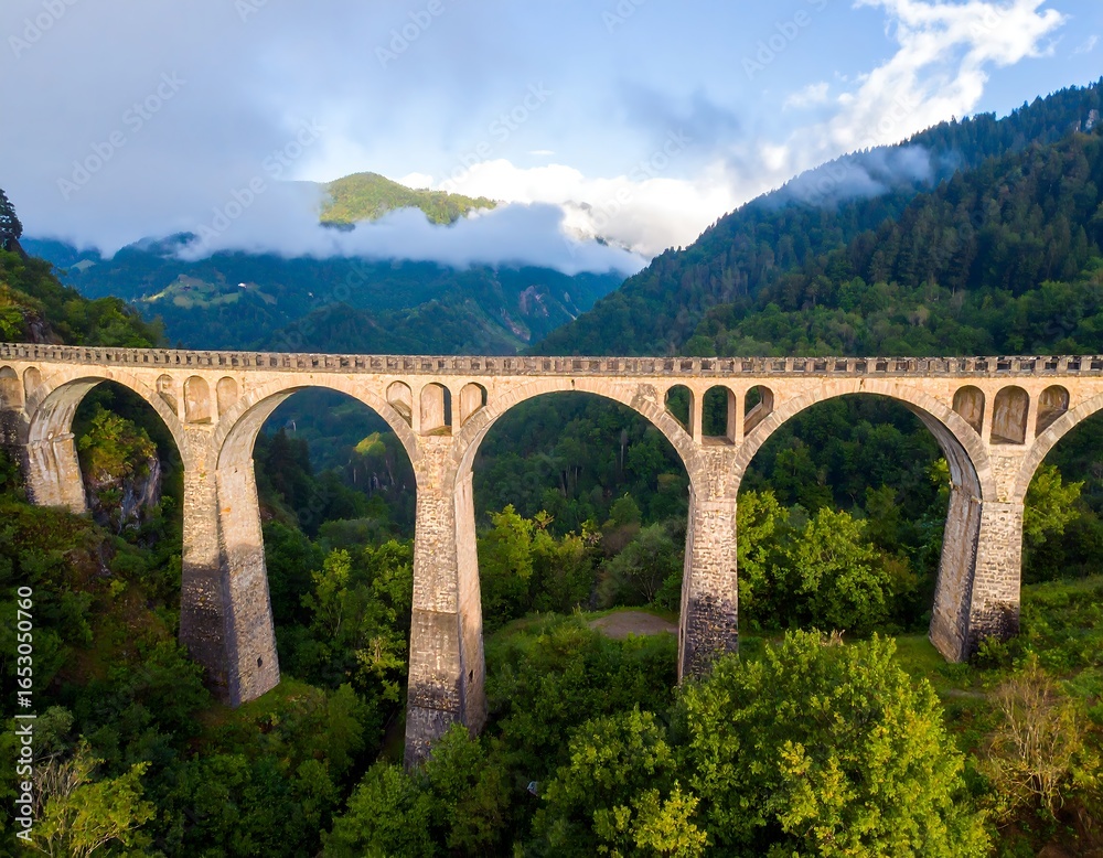 Fototapeta premium Mountain arch bridge spanning a valley