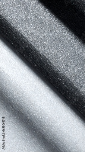 Diagonal grayscale fabric folds showing texture and light reflection