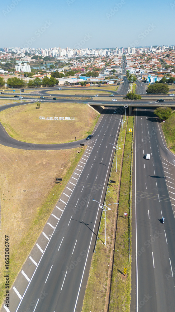 Fototapeta premium Aerial drone view of São José do Rio Preto city sign and highway in São Paulo state, Brazil