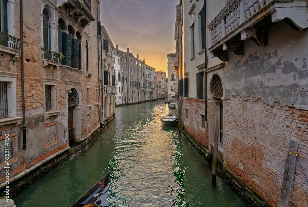 Fototapeta premium Venetian canal at sunset with historic buildings