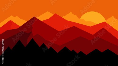 Impressive mountain range silhouette against a vibrant fiery evening sky