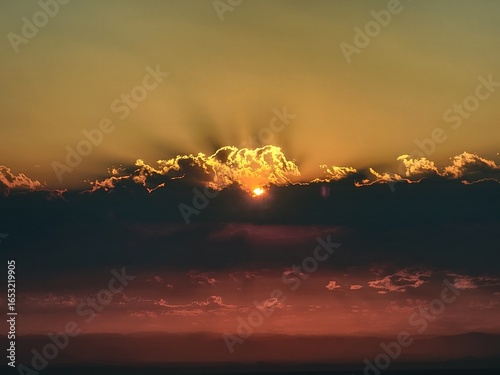 Sunrise over smoke and clouds