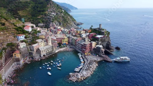 Aerial view of Vernazza, the most picturesque village in the Cinque Terre, consisting of colorful houses on the cliffs overlooking the sea on the eastern Ligurian Riviera. Liguria. Italy