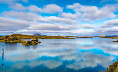 Fototapeta Naklejka Na Ścianę i Meble -  Amazing sunny day on lake Myvatn, Iceland, Europe. Beautiful clouds reflected in the blue water of a volcanic lake. Artistic picture. Beauty world. Travel concept. Panorama