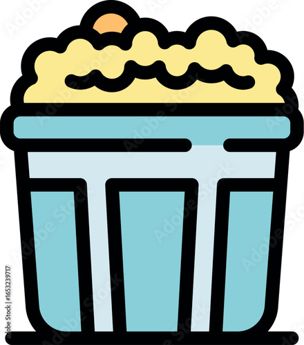 Tasty popcorn overflowing from a blue bucket