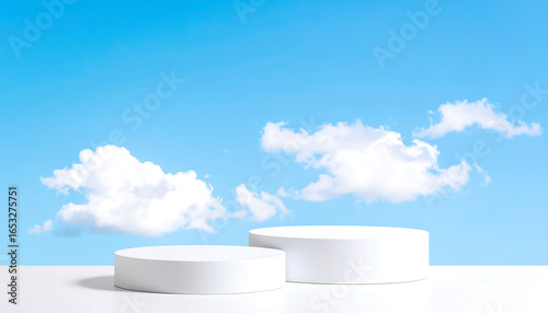 Serene Minimalist Product Display: Two White Cylindrical Platforms Against a Bright Blue Sky with Fluffy Clouds.