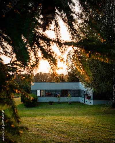 Photography Modern countryside house bathed in the warm light of the setting sun
