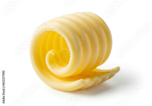 A single curl of fresh yellow butter on a white background