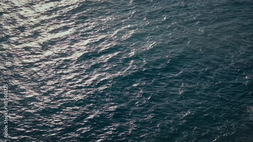 Close up drone footage looking down onto the deep blue sea