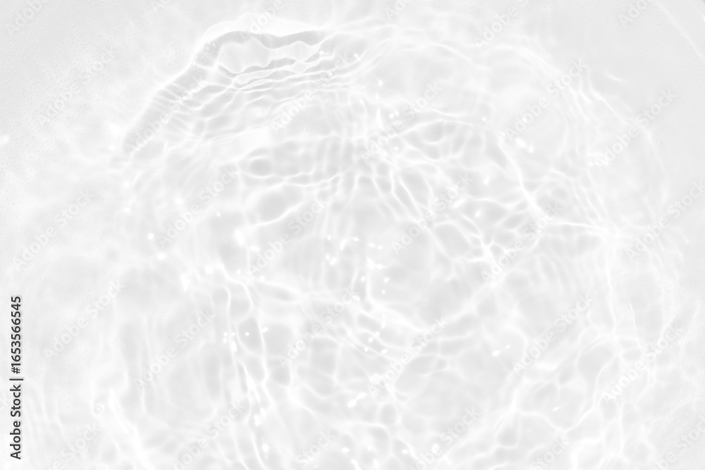 Obraz premium White water with ripples on the surface. Defocus blurred transparent white colored clear calm water surface texture with splashes and bubbles. Water waves with shining pattern texture background.