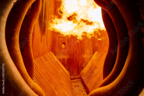 Intense flame combustion inside a steam boiler furnace at a thermal power plant showcasing heat exchange elements