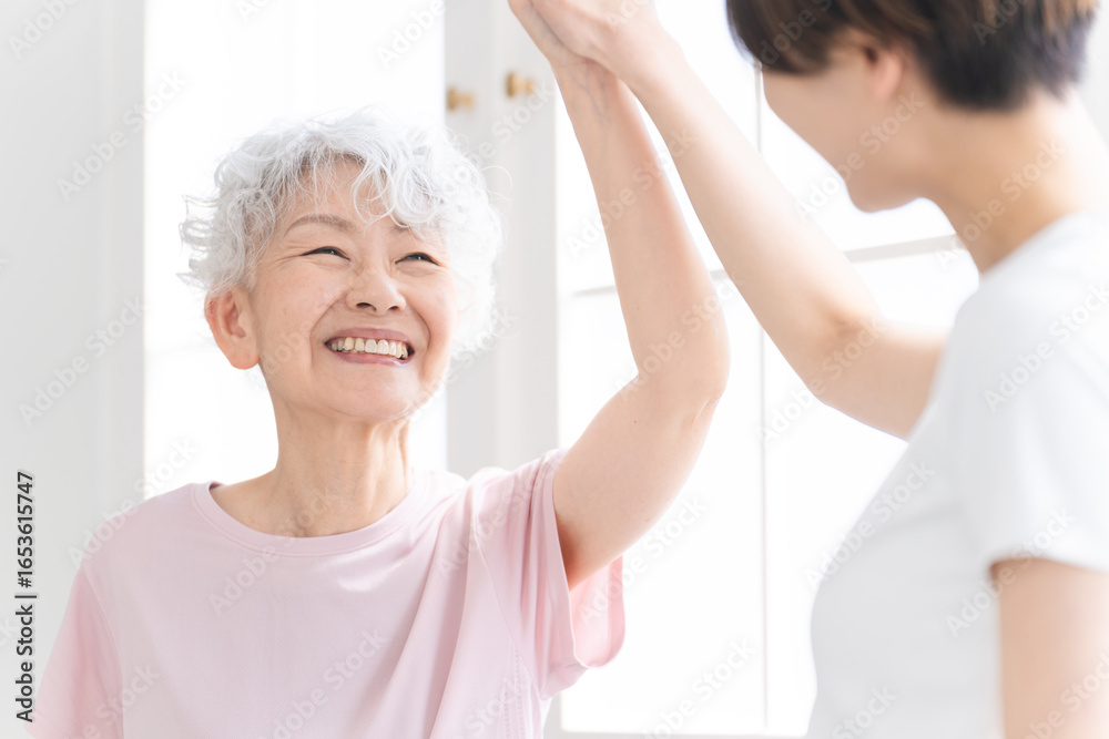 Fototapeta premium ヨガをする若い女性とシニア女性 健康イメージ