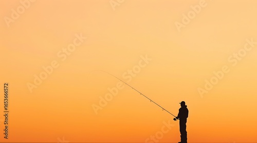 Lone angler silhouetted against a vibrant orange sunset sky