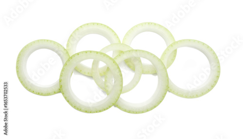 Stacked onion rings, pale yellow-green, arranged against a black background, create a visually appealing food image.