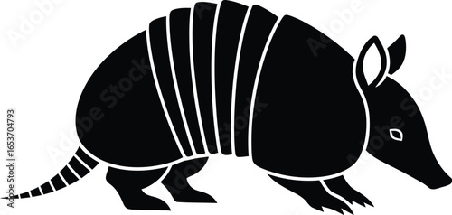 A black silhouette illustration of an armadillo with its segmented shell and tail, depicted in profile.