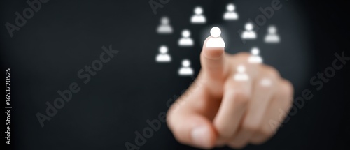 A person's hand, reaching out to select an avatar representing a choice within a network. Capturing the essence of selection.
